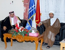 ولي عهد البحرين ورئيس كتلة الوفاق وعلم الجمعية بجوار علم البحرين.