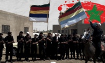 مقاتلون من حركة "رجال الكرامة" في مدينة السويداء - (تعديل عنب بلدي) مقاتلون من حركة "رجال الكرامة" في مدينة السويداء - (تعديل عنب بلدي)