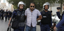 REUTERS/Hamad I Mohammed الناشط الحقوقي حسين الحاجي بين رجلي امن - موقع امنستي انترناشيونال