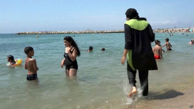 جدل البوركيني..امرأة تنزع قميصها على الشاطىء امام الشرطة 